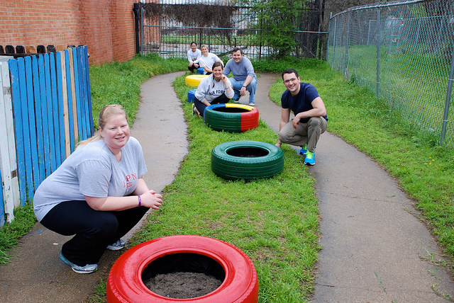 Community Volunteers and Volunteers from Neiman Marcus Group create fun outdoor learning area