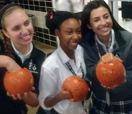 Girls holding pumpkins.jpg